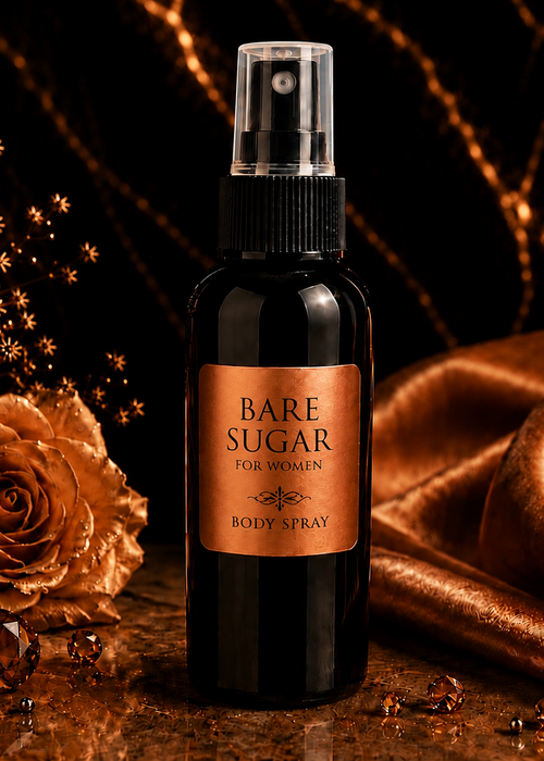 Bottle of Bare Sugar body spray with a rose and draped fabric on a dark background