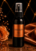 Emberon body spray bottle with decorative rose and fabric on a dark background
