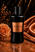 Black bottle of Soline body wash with a rose and satin fabric on a dark background